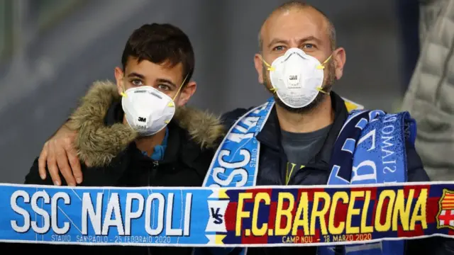 Fans at the Napoli v Barcelona Champions League game wearing face masks