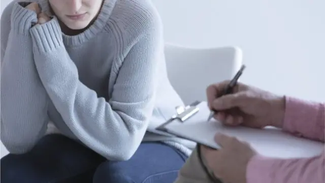 A woman speaking to a health professional