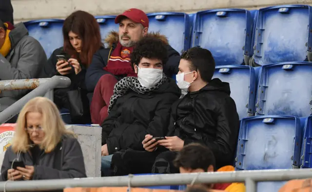 Fans wear face masks to a football match in Italy