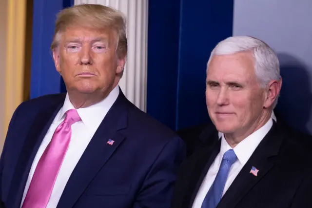 U.S. President Donald Trump looks on after a news conference with Vice President Mike Pence