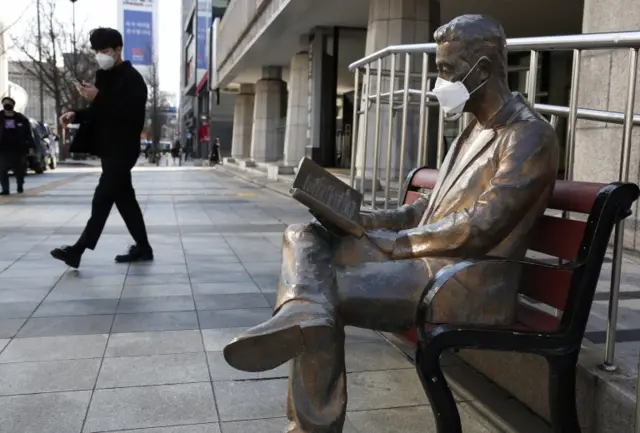 Statue wearing health mask