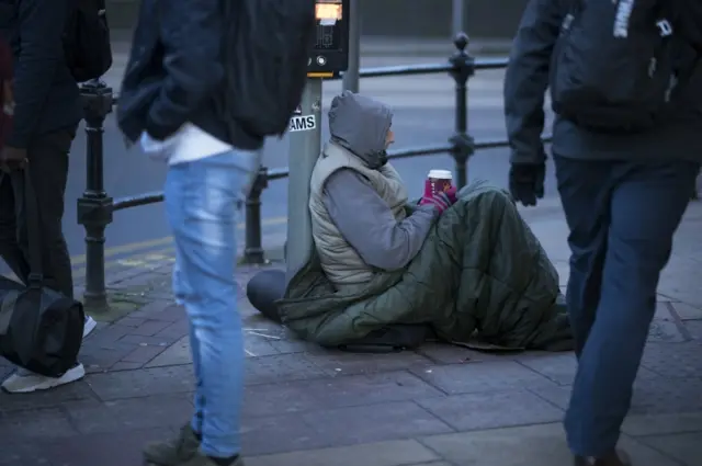 A homeless man on a street