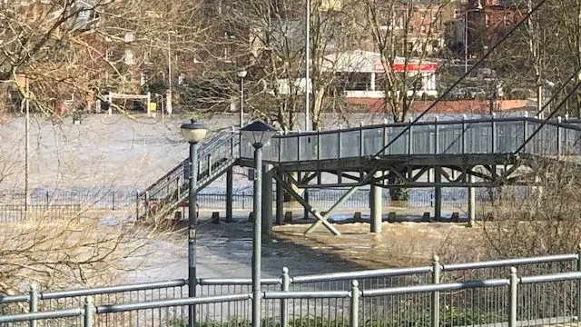 Floodwater around footbridge