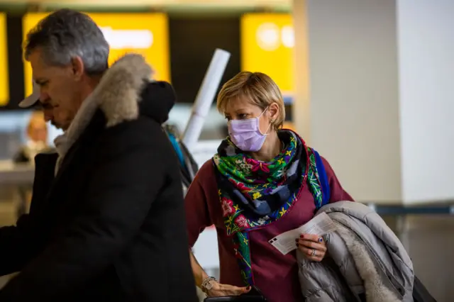 A passenger wears a face mask at Airport Tegel on February 03, 2020 in Berlin, Germany.