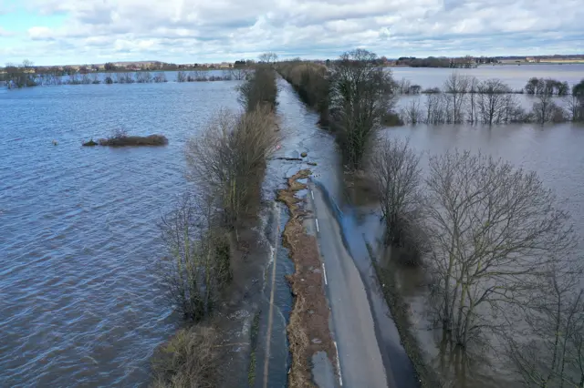 Flooded road in the middle of a field