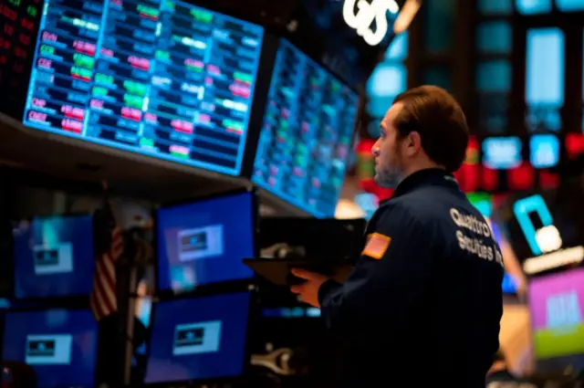 Traders work during the opening bell at the New York Stock Exchange (NYSE) on February 27