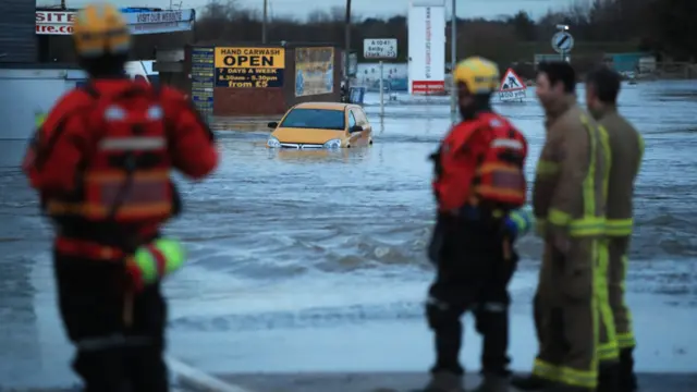 Firefighters at flood water