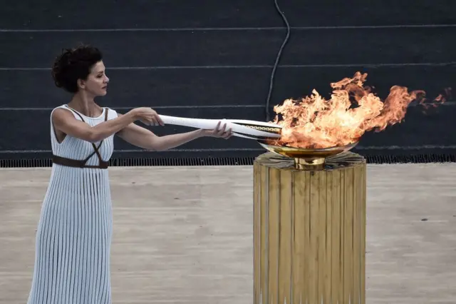 Actress Katerina Lechou lights the olympic torch, at The Panathenaic Stadium in Athens on October 31, 2017