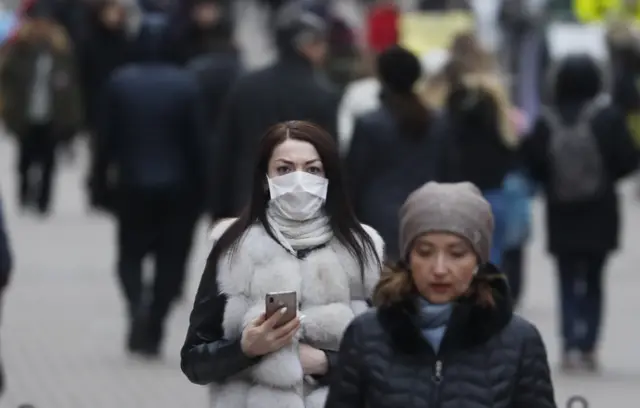 A woman wears a protective mask in Moscow