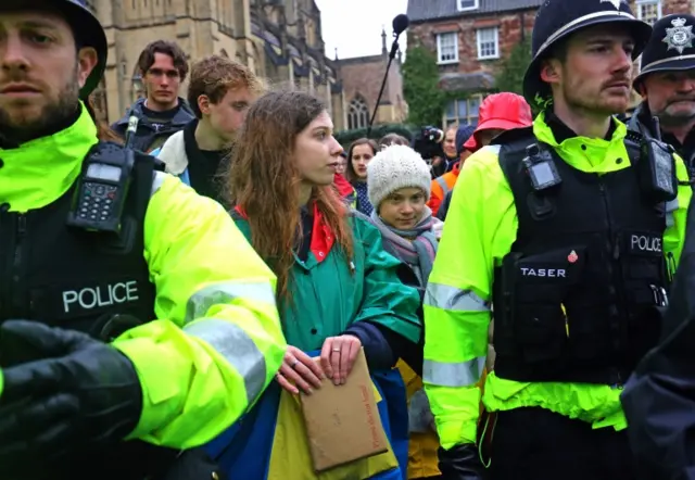 Greta being escorted by police