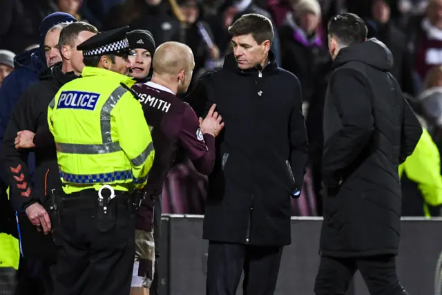 Steven Naismith and Steven Gerrard exchange words at the half-time whistle