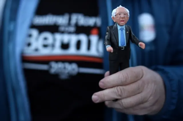 A supporter holds a Bernie action figure