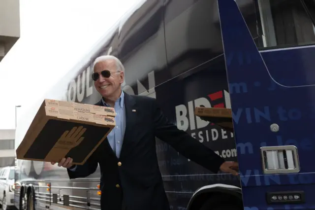 Biden steps off his campaign bus on caucus morning in Des Moines