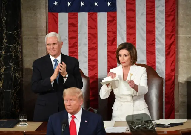 US Vice President Mike Pence claps as Speaker of the US House of Representatives Nancy Pelosi rips a copy of US President Donald Trump speech