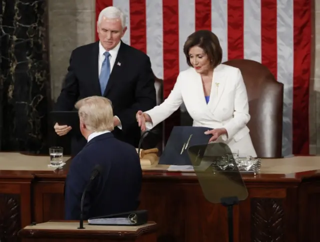 Nancy Pelosi (D-CA) and Vice President Mike Pence look on as President Donald Trump