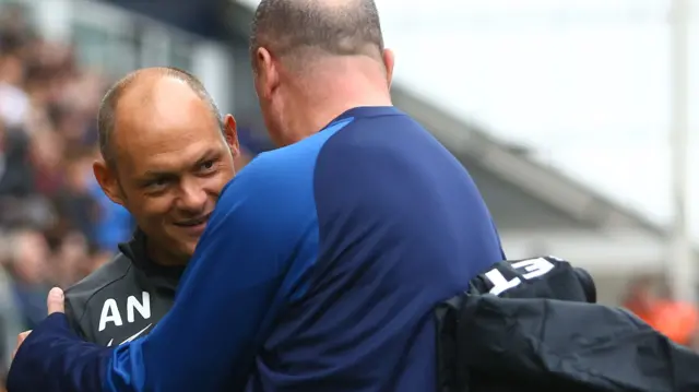 Alex Neil (left) and Paul Cook embrace