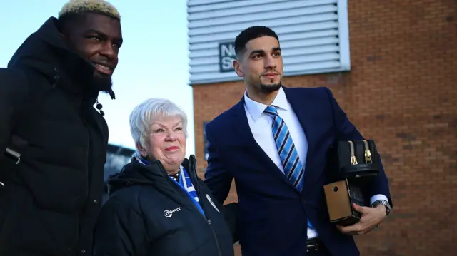 Wigan players pose for a photo with a fan