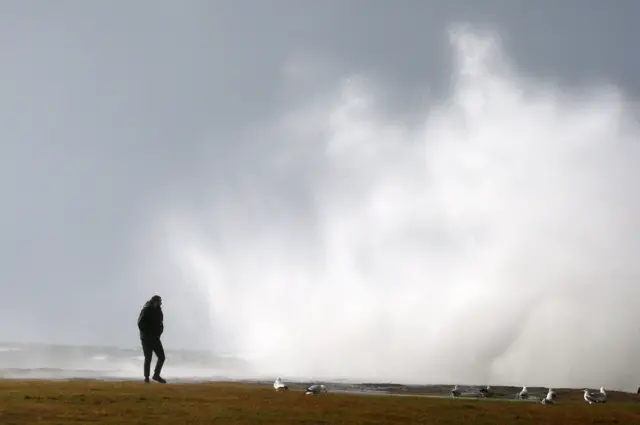 An onlooker watches windy weather on the Ayrshire coast in Scotland