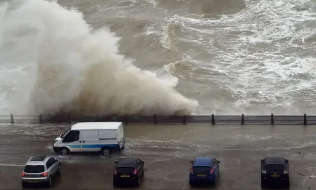 Waves crash over the wall at Newhaven Harbour, East Sussex