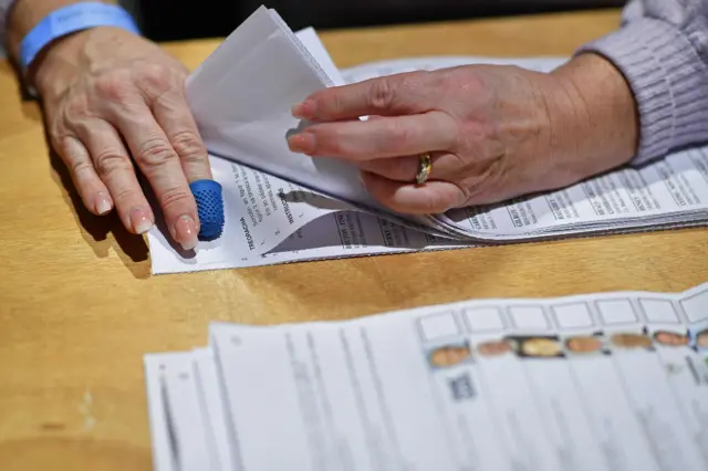 Hands on voting papers