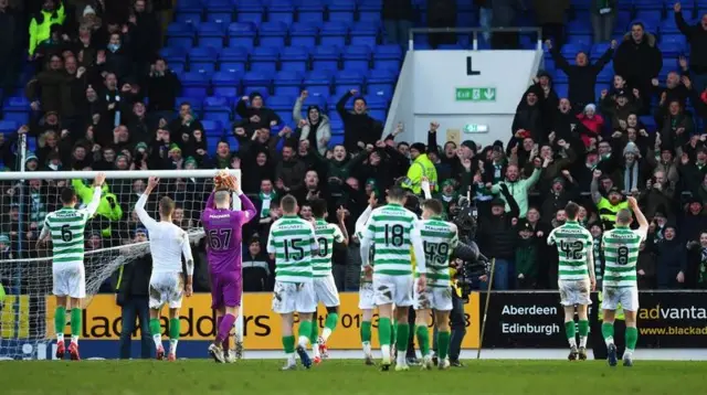 Celtic players acknowledge the large travelling support in Perth