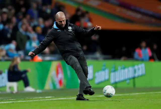 Pep Guardiola kicking the ball