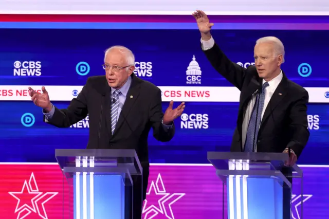 Democratic presidential candidate Bernie Sanders speaks as Joe Biden reacts during the Democratic presidential primary debate on 25 February, 2020 in Charleston, South Carolina