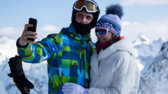 Couple taking a selfie on a skiing holiday