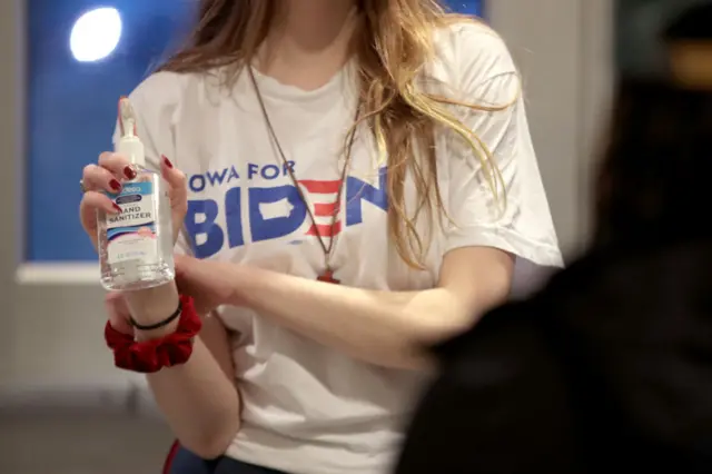 A campaign worker offers hand sanitiser to guests at a rally with Democratic presidential candidate former Vice President Joe Biden at Renaissance High School on 9 March, 2020 in Detroit, Michigan