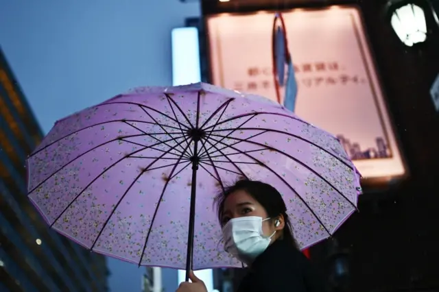 A woman wears a mask in Tokyo, Japan. Photo: 10 March 2020