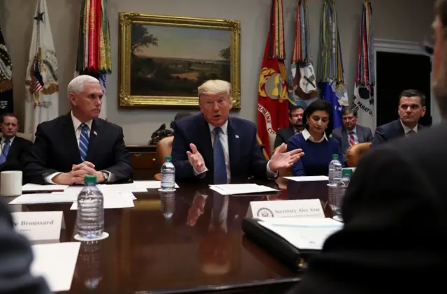 President Donald Trump speaks next to Vice President Mike Pence during a coronavirus briefing with health insurers