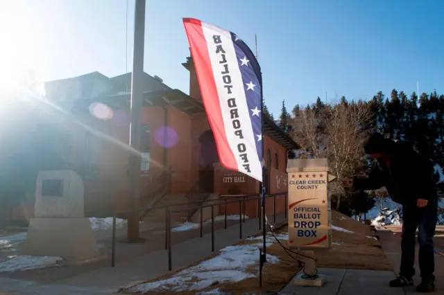 A voter drops off his ballot for the presidential primary election at the Idaho Springs City Hall in Idaho Springs, Colorado on Super Tuesday, 3 March, 2020