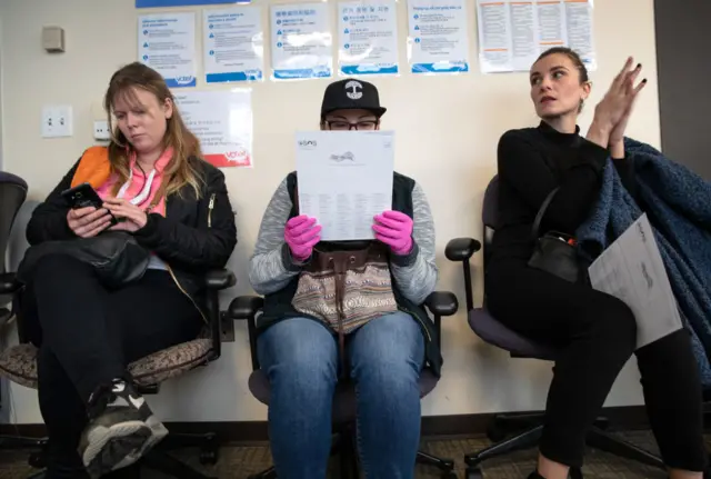 Voters wait to register before casting their ballots in primary elections on March 10, 2020 in Seattle, Washington