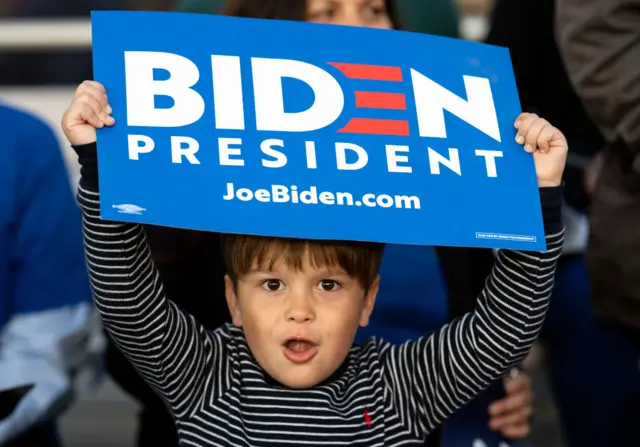 A child holds a Joe Biden placard during a campaign rally