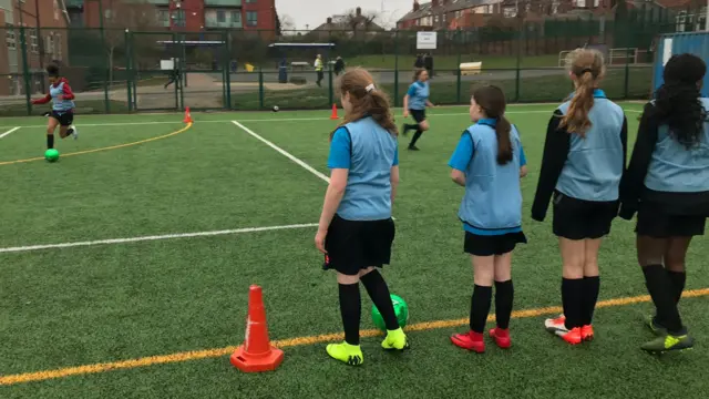 Girls playing football