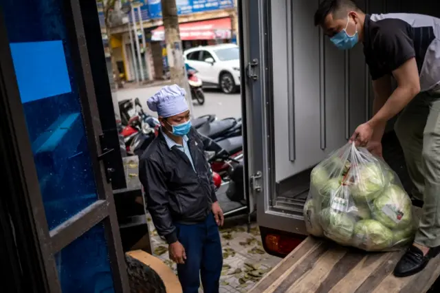 This picture shows food being delivered to the quarantined area of Truc Bach Street in Hanoi.