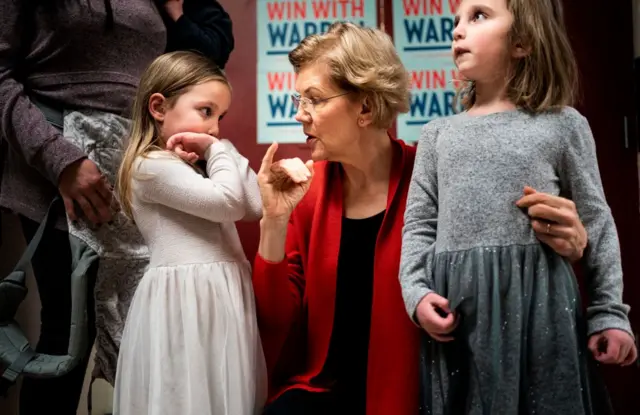 Democratic Presidential Candidate Senator Elizabeth Warren makes pinky promises with little girls and takers selfies before a get out the vote event at Rundlett Middle School in Concord, New Hampshire on 9 February, 2020