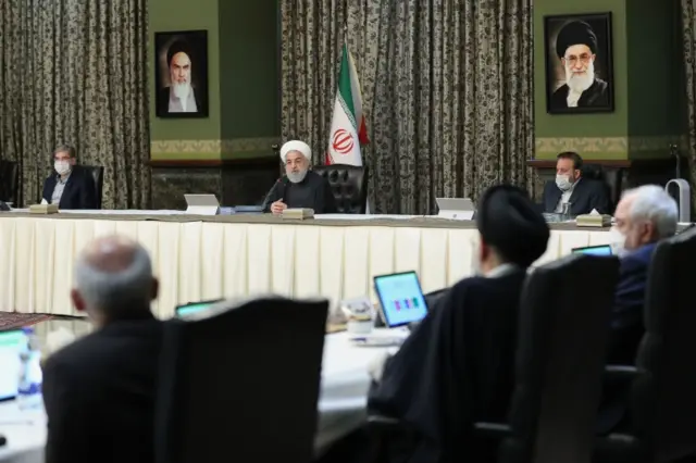 Iranian President Hassan Rouhani (centre) speaks as ministers wear face masks and gloves at a cabinet meeting in Tehran (11 March 2020)