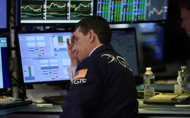 A stock exchange worker looks despondent