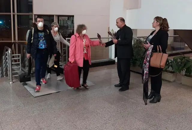 Handout photo from Egyptian Ministry of Tourism and Antiquities showing a group of French and American tourists at Cairo airport after being released from quarantine (10 March 2020)