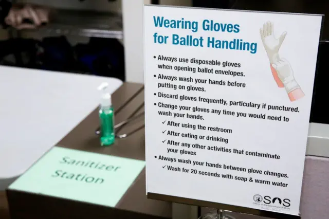 A hand sanitiser station is set up for election workers sorting vote-by-mail ballots for the presidential primary at King County Elections in Renton, Washington on March 10, 2020