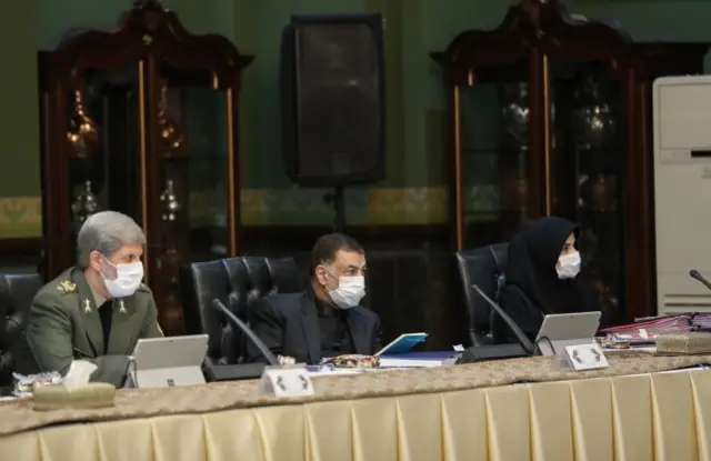 Iranian ministers wear face masks and gloves at a cabinet meeting in Tehran (11 March 2020)