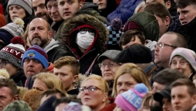 Supporter wears face mask at a Premier League game