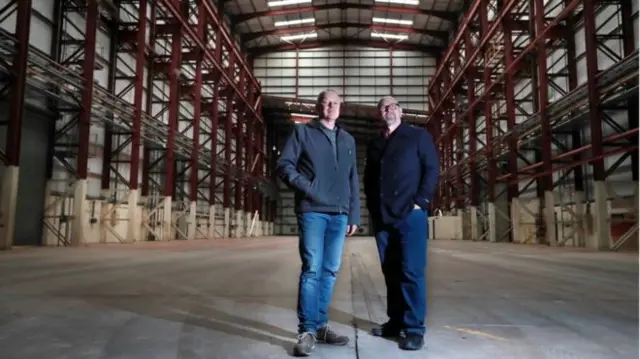 Bob Last (L) and Jason Connery (R) inside the huge building