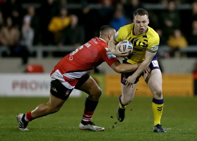 Wigan's Liam Marshall tries to bust a tackle