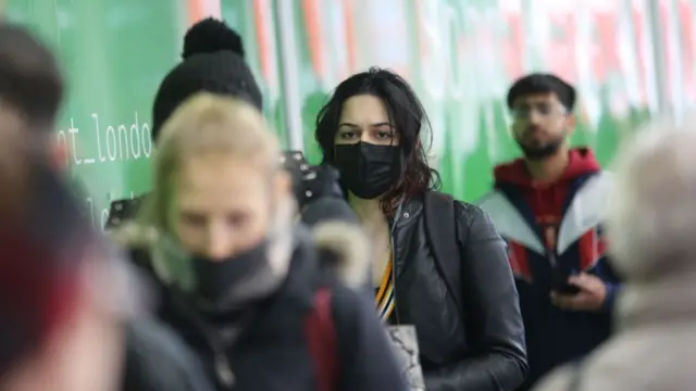 A woman wearing a surgical mask in London