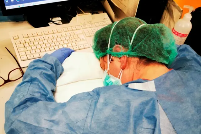 A nurse rests during a night shift at a hospital in Cremona, Italy March 8, 2020, in this image obtained from social media