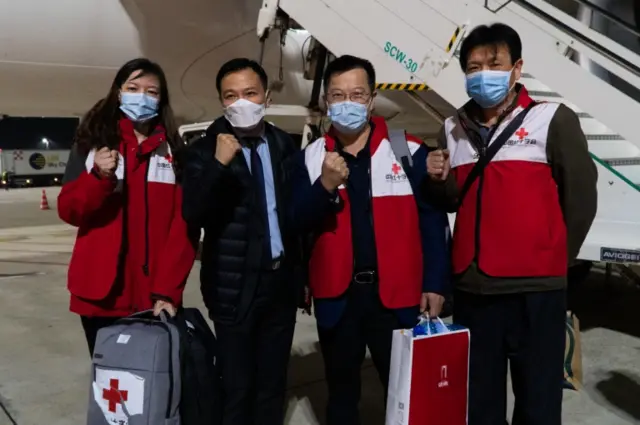 A handout photo made available on 13 March 2020 by the Italian Red Cross Press Office shows Chinese doctors specialised in the fight against coronavirus after arriving from Shanghai in Rome (12 March 2020)