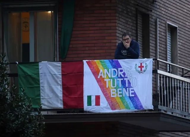 A man at an apartment balcony in Milan on 14 March 2020