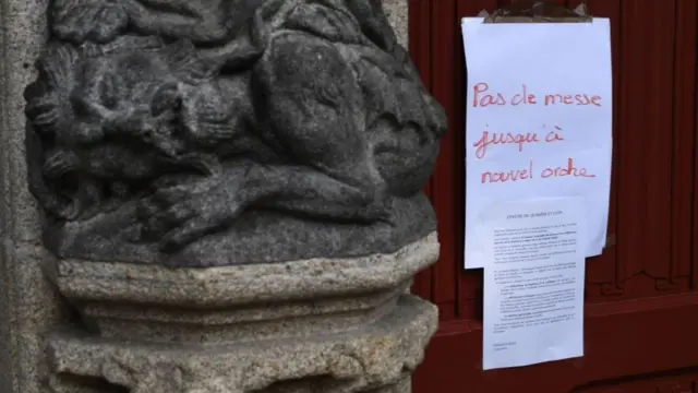 A sign affixed to the main door of the cathedral says "No Mass until further notice" in Quimper, western France on March 15, 2020, as France battles the coronavirus that causes the COVID-19 disease